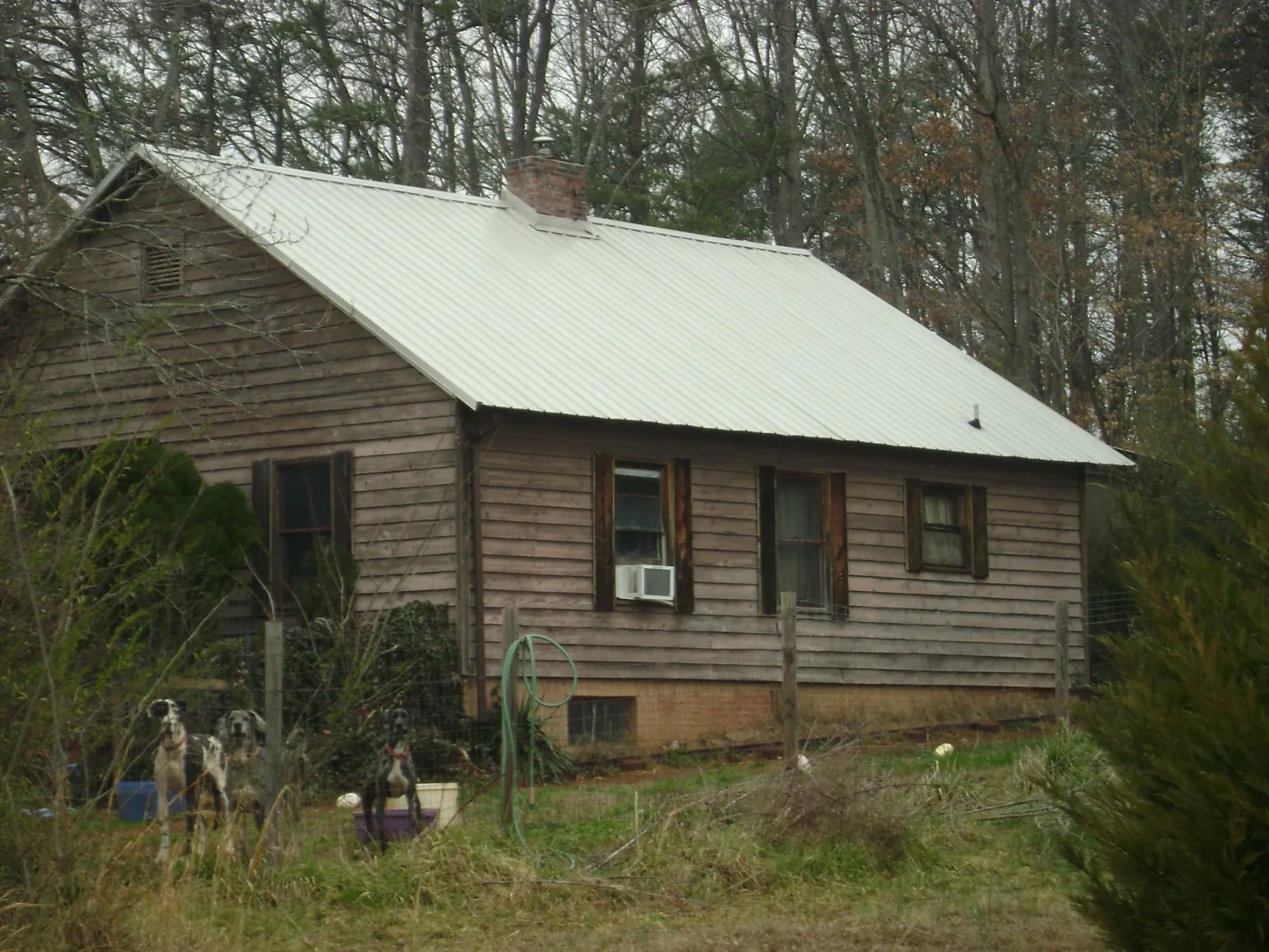 White metal roof on an old wood sided farmhouse, from a Metal Roof Installation job in Townsend